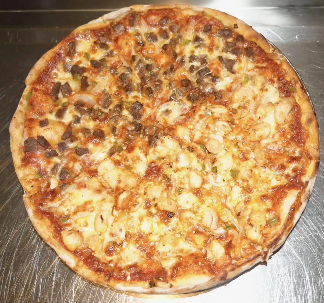 Medium Hot & Spicy Pizza Freshly baked dough topped with pizza sauce, hot pepper, mozzarella cheese, minced meat, diced chicken, and vegetables.